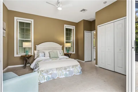 a bedroom with a large bed and a chandelier