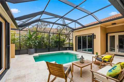 a view of a backyard with table and chairs under an umbrella