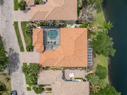 an aerial view of a house with yard swimming pool and outdoor seating