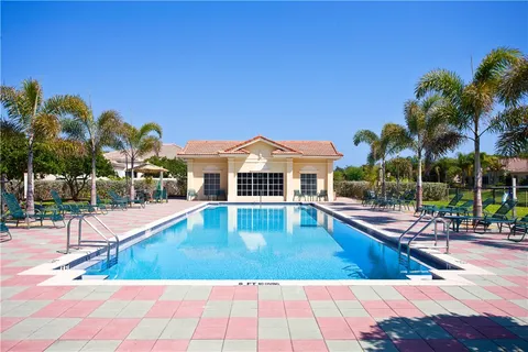 a view of a swimming pool with lounge chairs