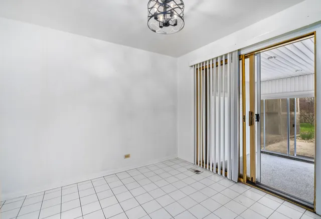 a view of a livingroom with an empty space and a window