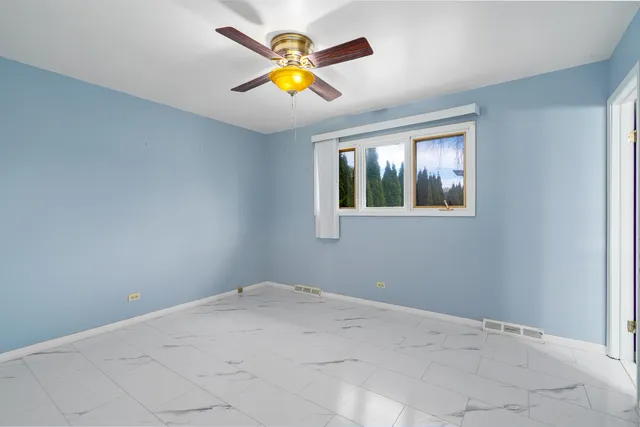 a view of a wooden floor and chandelier fan