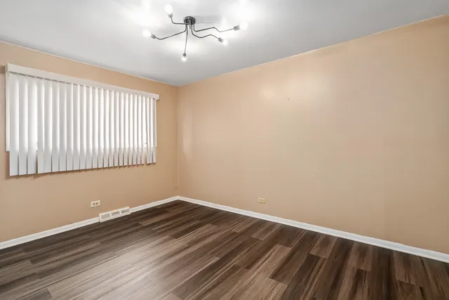 a view of a room with wooden floor and windows