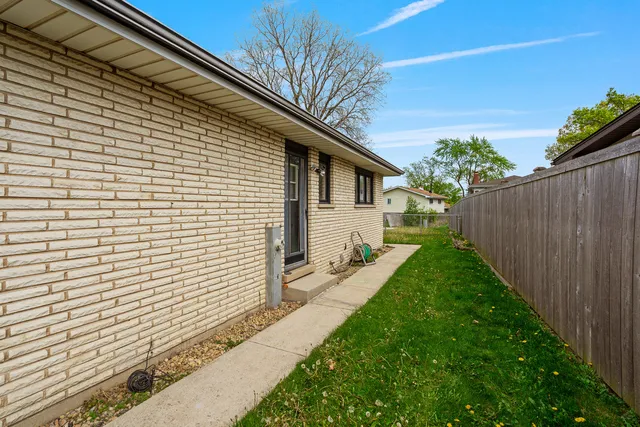 a view of a big house with a big yard and large trees