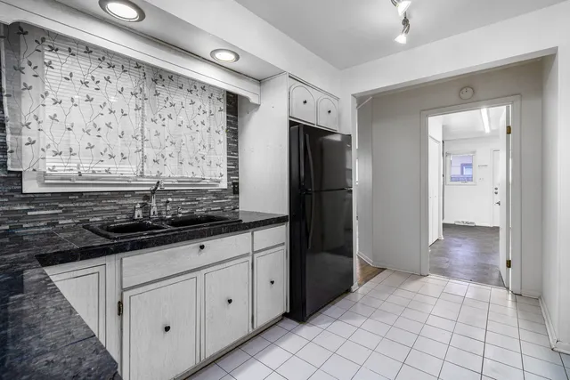 a kitchen with stainless steel appliances a sink and a refrigerator