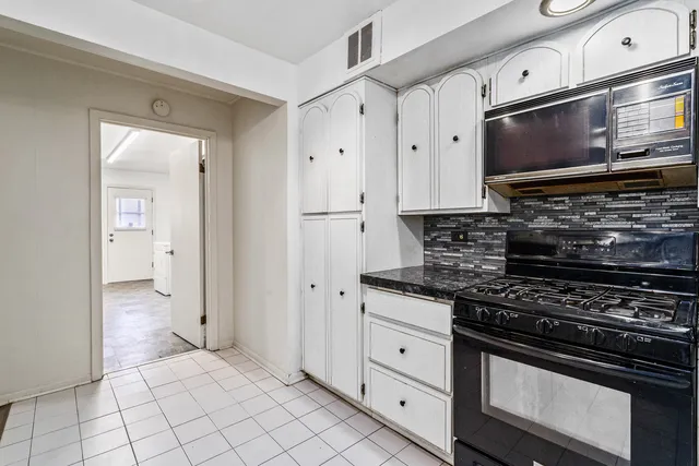 a kitchen with stainless steel appliances and cabinets