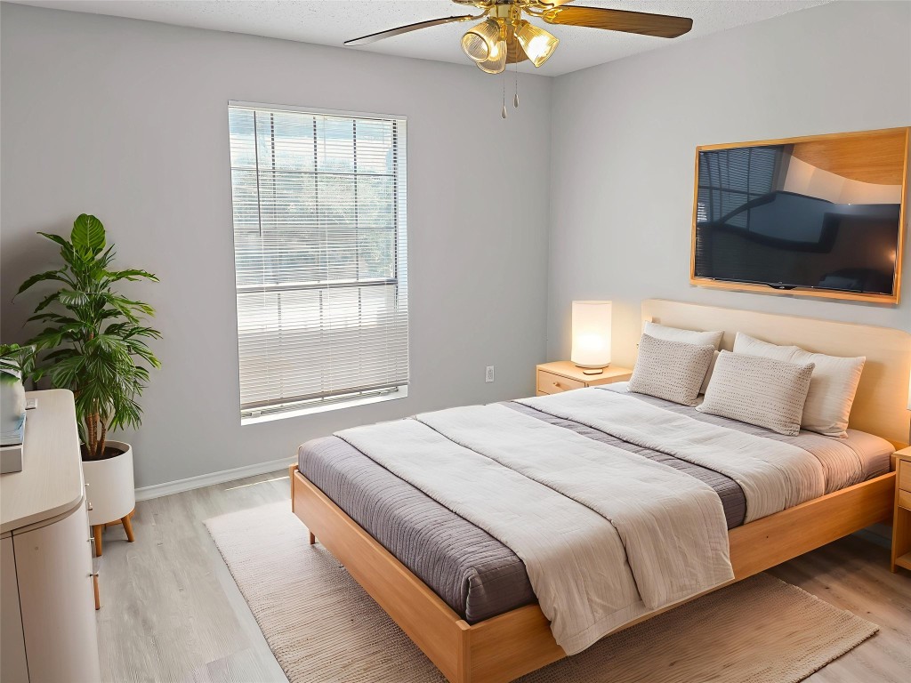 2nd Bedroom featuring light wood-style flooring, a textured ceiling, and ceiling fan