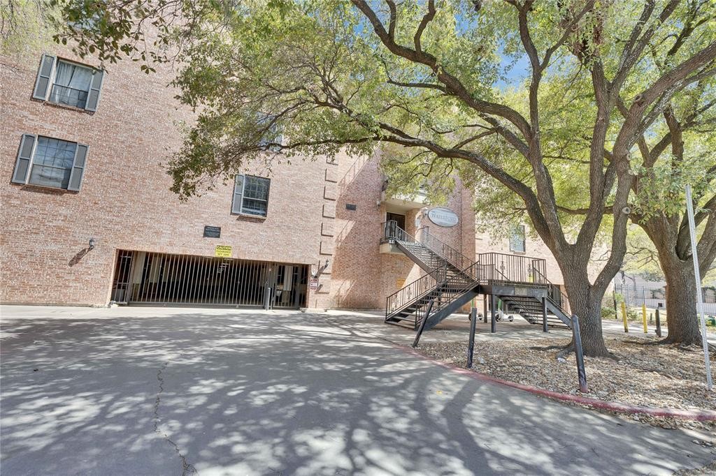 2401 Leon Street, Unit 110 Austin, TX 78705 - Photo 12 of 13 View of building exterior with stairway and driveway