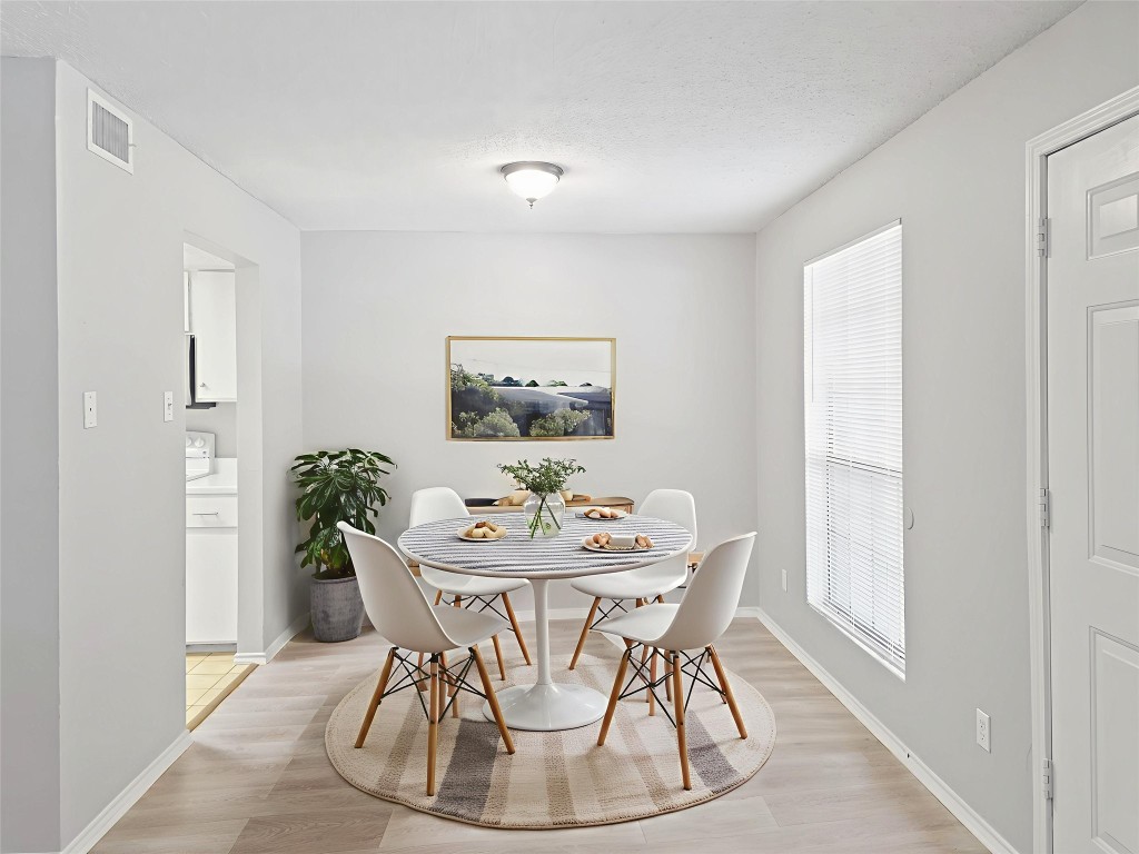 2401 Leon Street, Unit 110 Austin, TX 78705 - Photo 6 of 13 Dining space featuring light wood-style floors and a textured ceiling