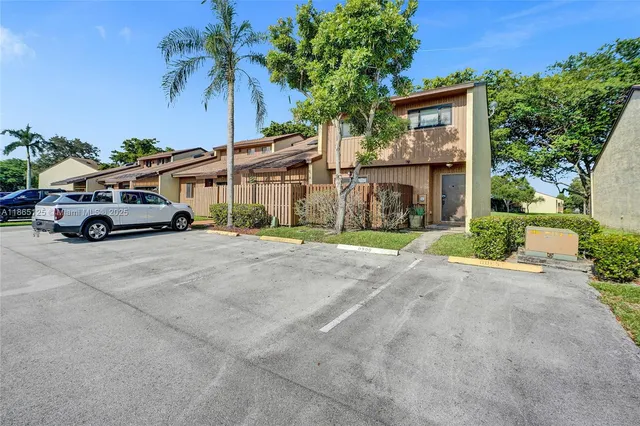 a car parked in front of white house