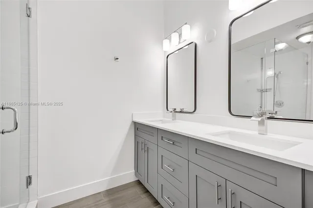 a bathroom with a granite countertop toilet a sink and shower