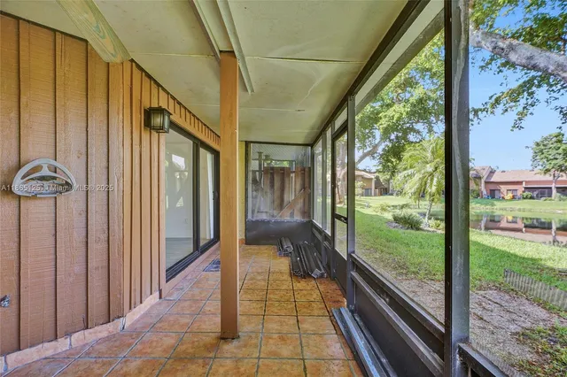 a view of a lake with a yard large trees and plants