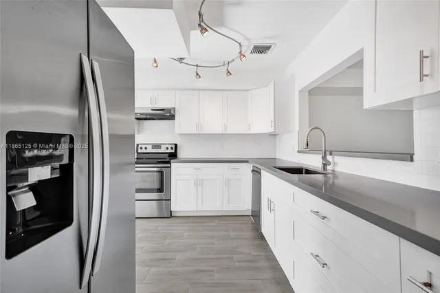 a view of a hallway with a dining table