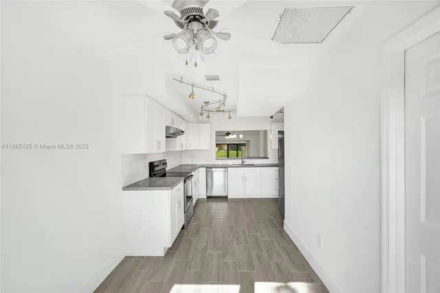 a view of a hallway with washer and dryer