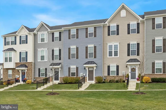 a front view of building with yard and green space