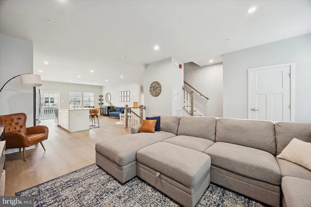 a living room with furniture and kitchen view
