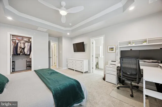a bedroom with a bed furniture and a flat screen tv
