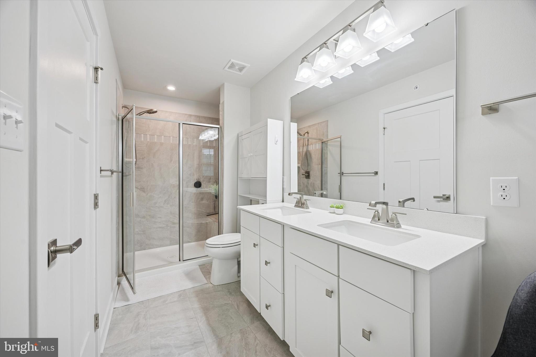 135 Bishop Way Dublin, PA 18917 - Photo 16 of 24 a spacious bathroom with a double vanity sink mirror and toilet