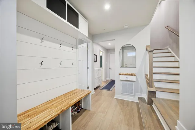 a kitchen with cabinets and wooden floor
