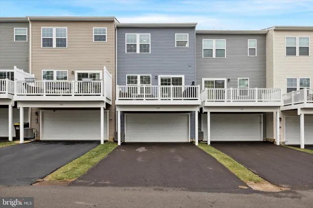a front view of residential houses with yard