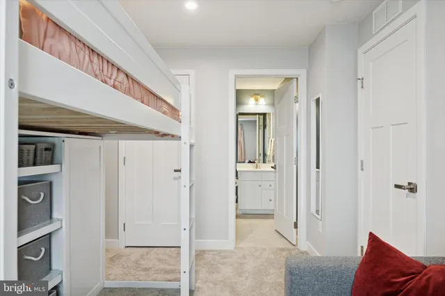 a view of a hallway with closet and bathroom