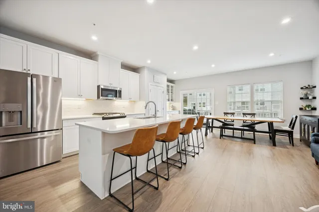 a kitchen with counter top space a sink appliances and cabinets