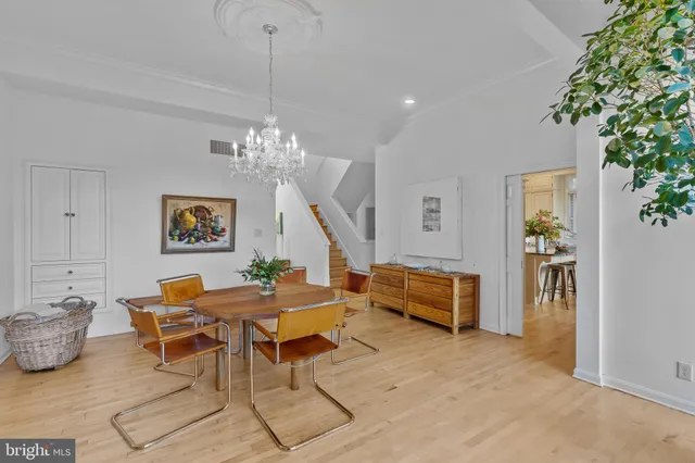a dining room with furniture and a chandelier