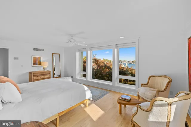 a bedroom with furniture and a large window