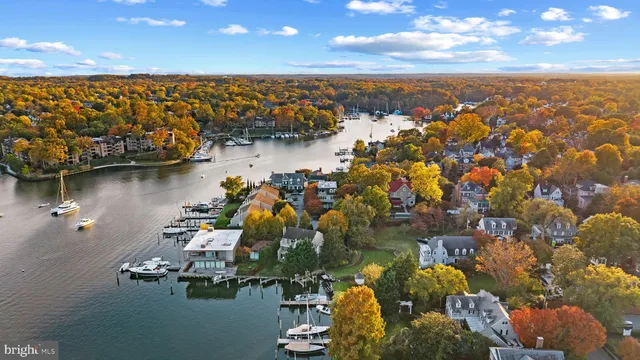 an aerial view of ocean and residential houses with outdoor space