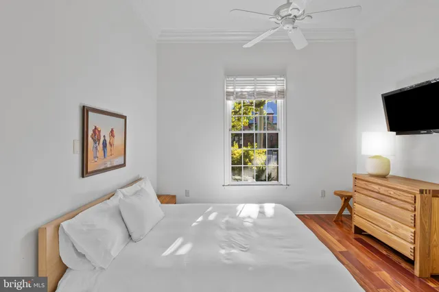 a bedroom with a bed and a television