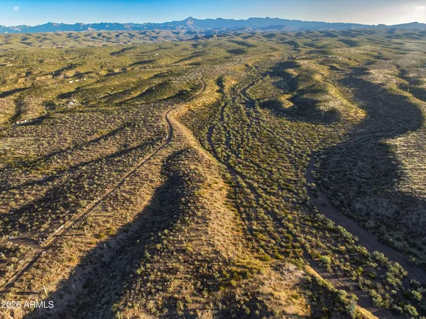 a view of a large body of water with a building in background