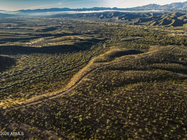 a view of a large body of water with a house in background
