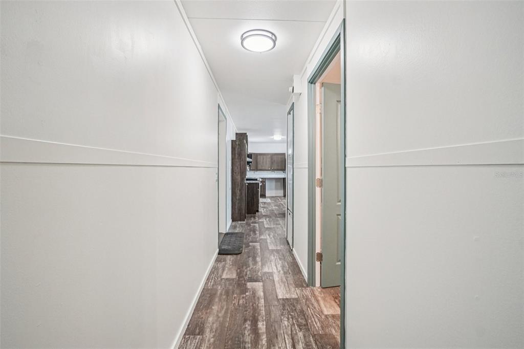 808 Southwest 124th Lane Webster, FL 33597 - Photo 11 of 18 a view of a hallway with wooden floor and staircase