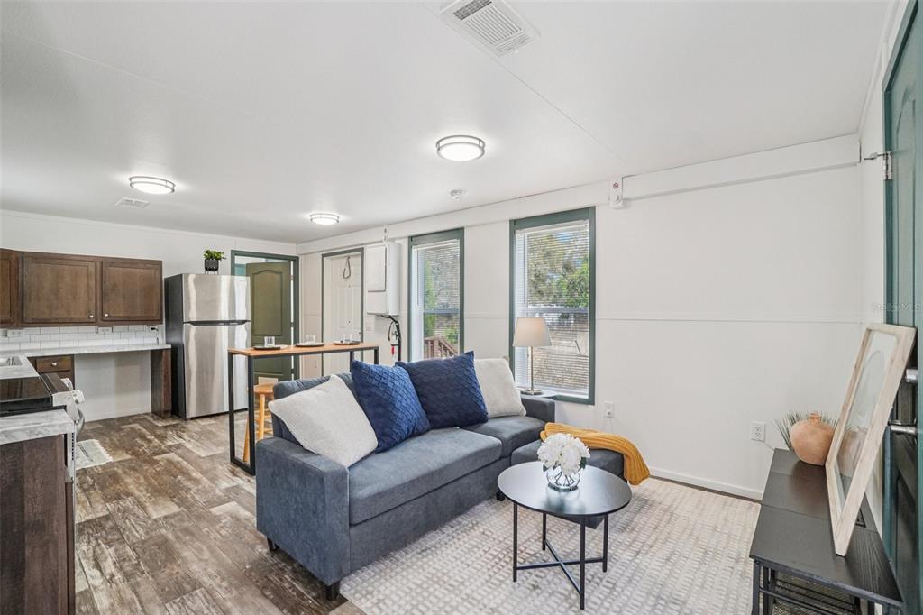 808 Southwest 124th Lane Webster, FL 33597 - Photo 3 of 18 a living room with furniture and a flat screen tv