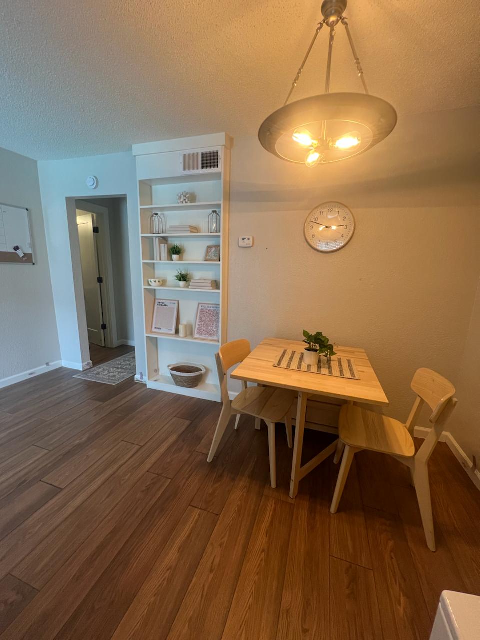2401 Manor St Road, Unit 118 Austin, TX 78722 - Photo 8 of 17 a view of a dining room with furniture and wooden floor