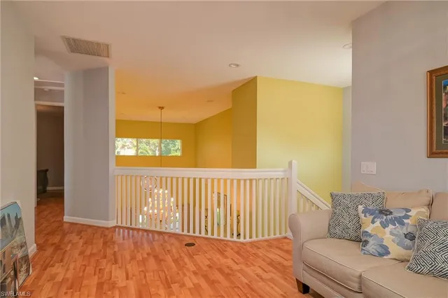 a view of a bedroom with furniture and wooden floor