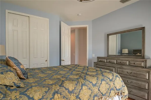 a bedroom with a bed and a mirror