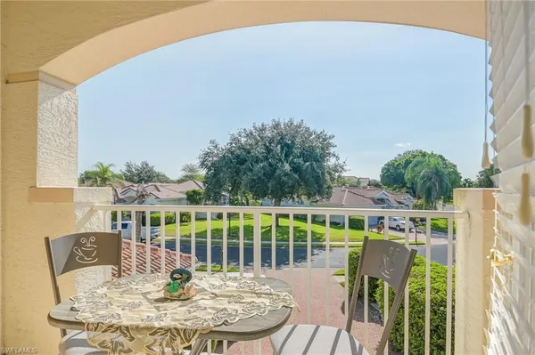 a view of a chairs and table in patio