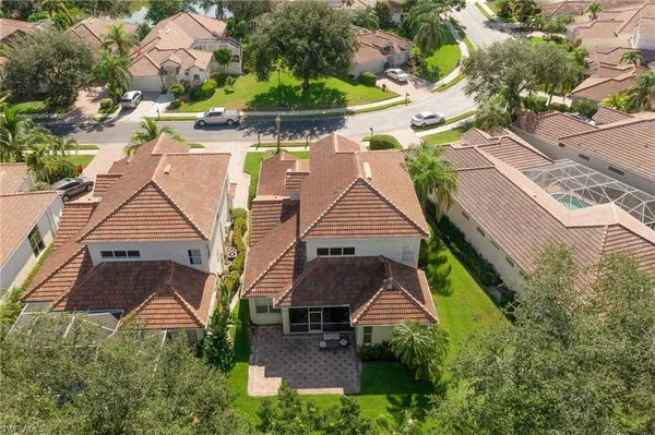 an aerial view of multiple houses with yard