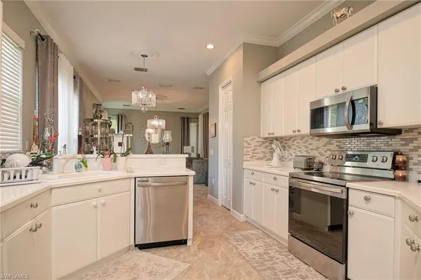a kitchen with a sink stove and cabinets