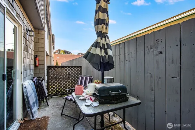 a backyard of a house with table and chairs