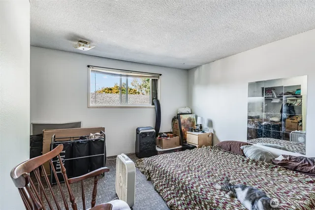 a bedroom with bed and wooden floor