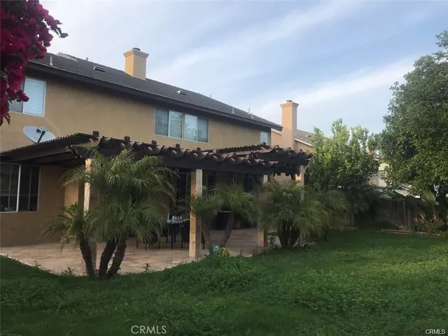 a view of a backyard of a house with a patio