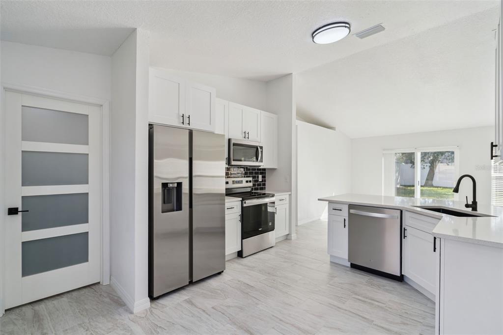 3215 Colusa Street Deltona, FL 32738 - Photo 15 of 32 a kitchen with a refrigerator sink and cabinets