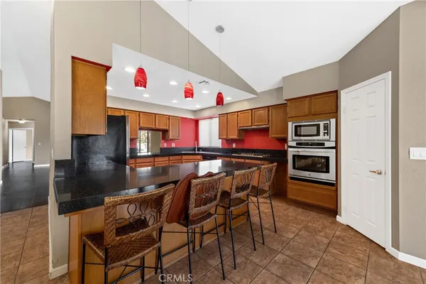 a kitchen with granite countertop sink cabinets and window