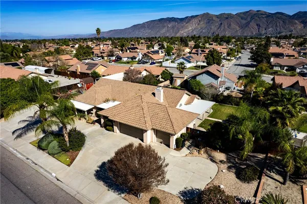 an aerial view of a house with garden space and street view