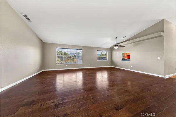 a view of a livingroom with wooden floor and window