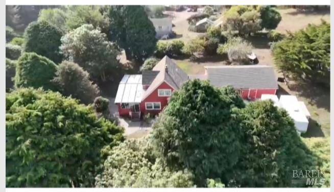 an aerial view of a house with a yard and garden