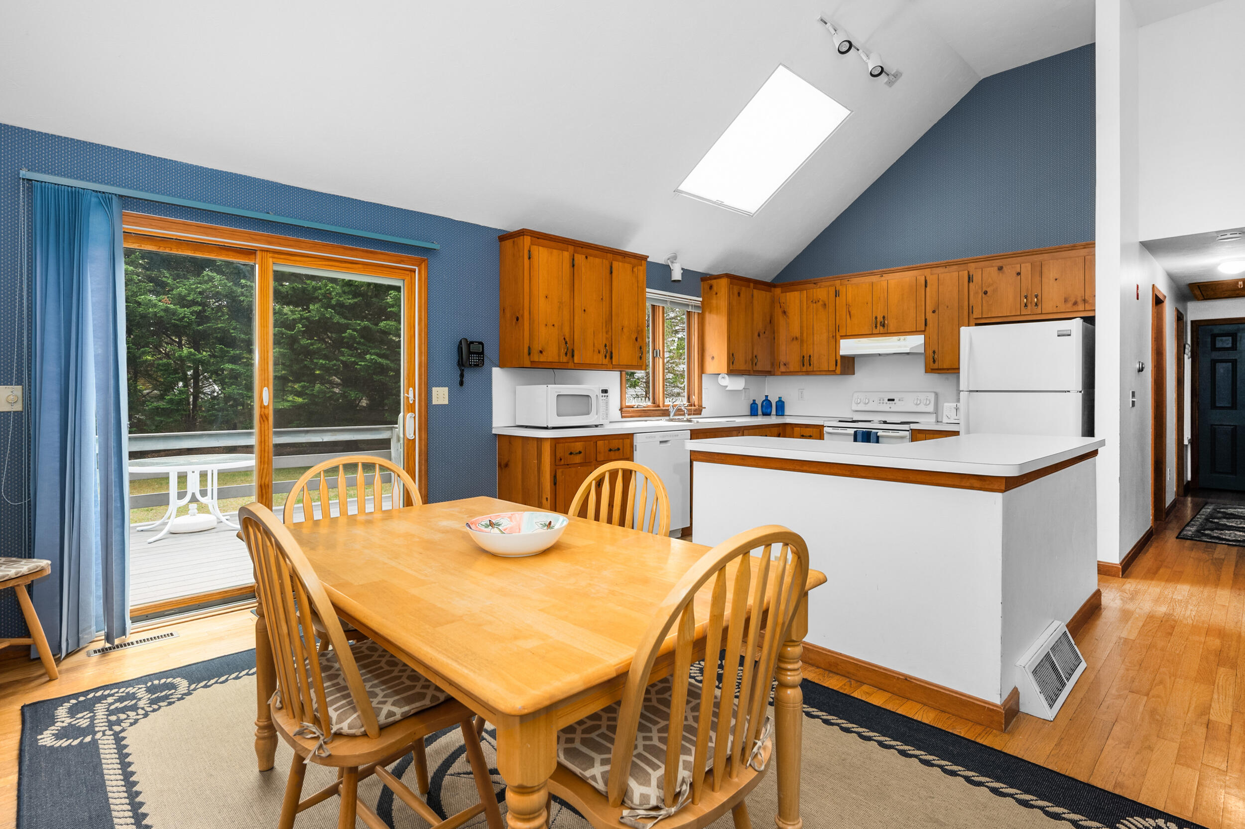 5 Blueberry Island Road Orleans, MA 02653 - Photo 15 of 39 a kitchen with a table chairs refrigerator and cabinets