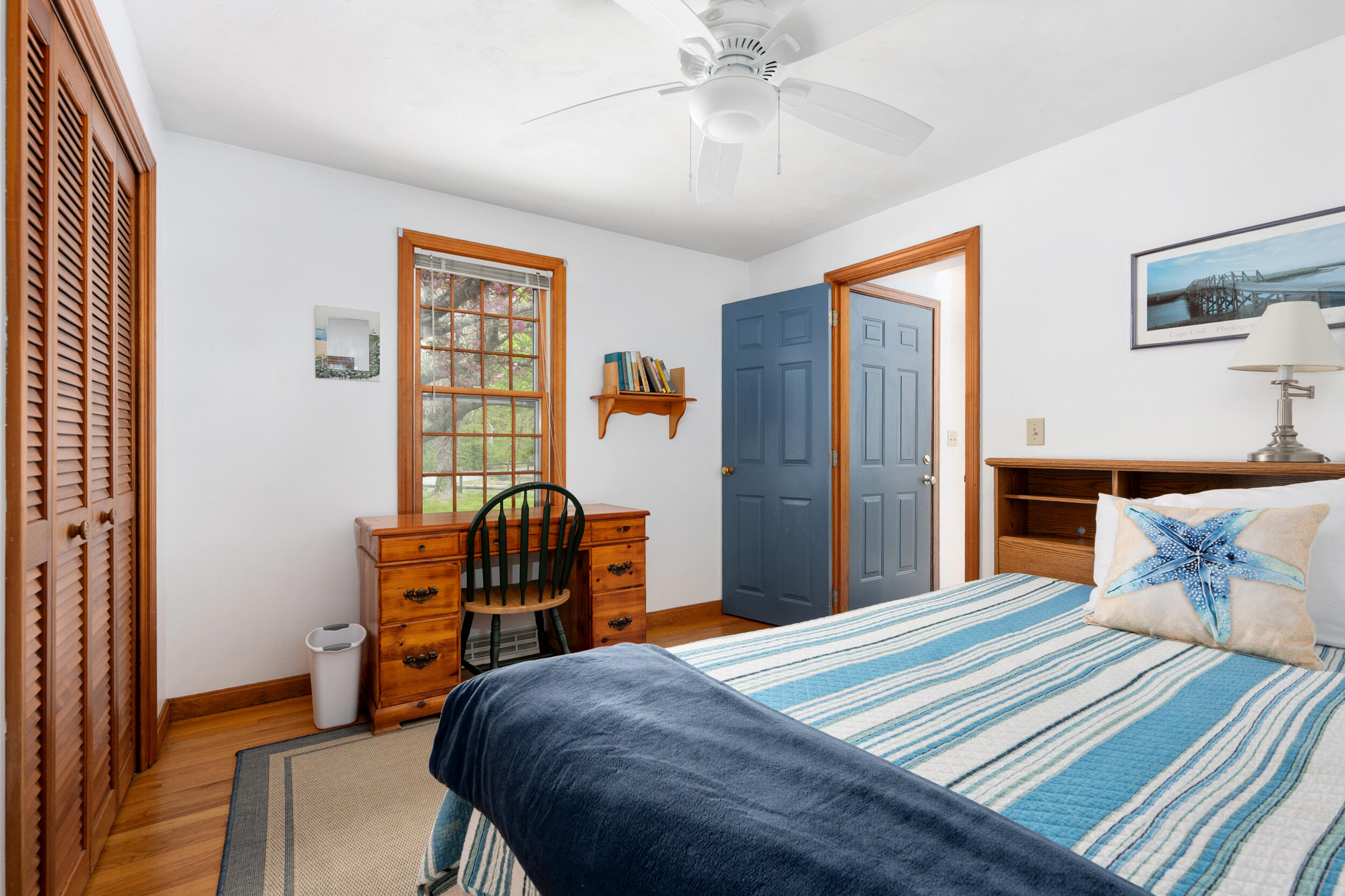 5 Blueberry Island Road Orleans, MA 02653 - Photo 18 of 39 a bedroom with a bed and a chandelier